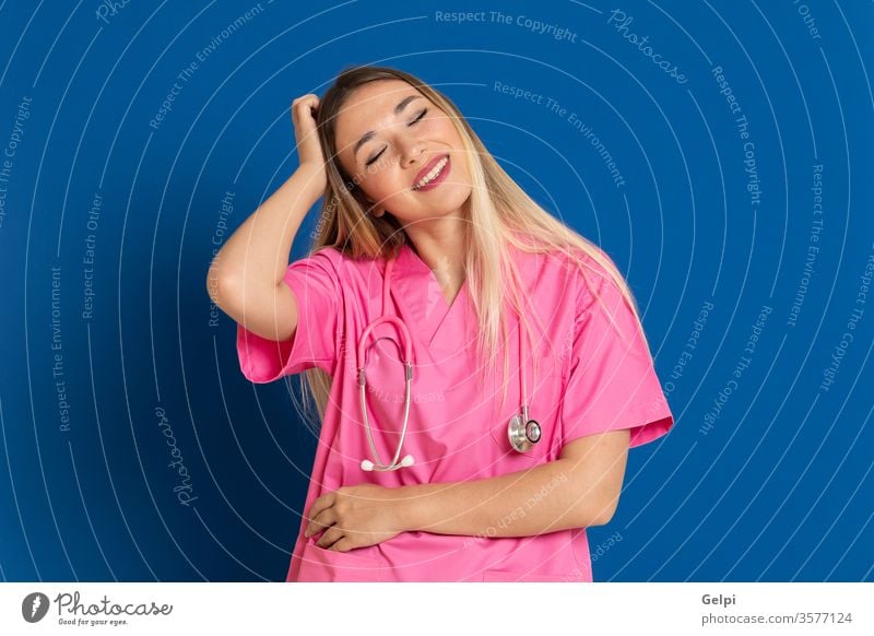 Blonde doctor with pink uniform blue health smile doubt imagination idea dream dreamer think pensive review caucasian medical woman person nurse white female