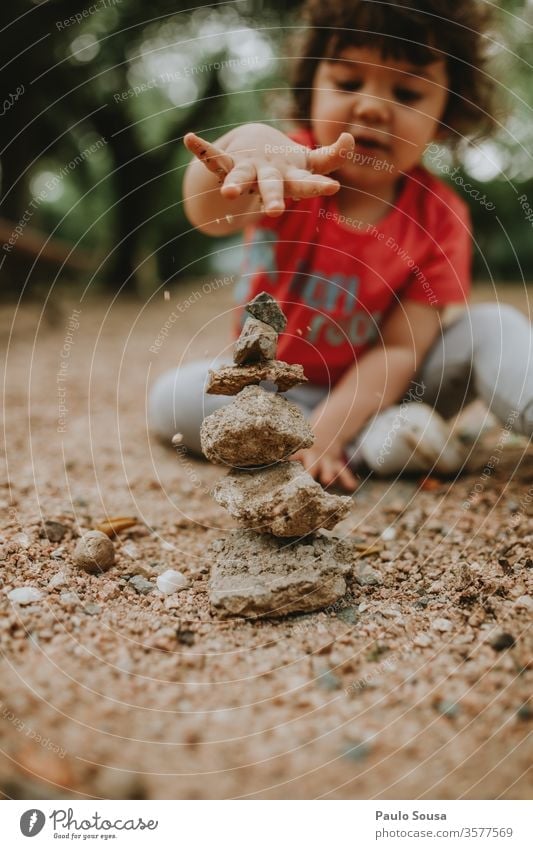 Child playing with sand Sand rocks Stone Children's game childhood Playing outdoors Nature equilibrium Balance Balanced Colour photo Infancy Exterior shot Joy