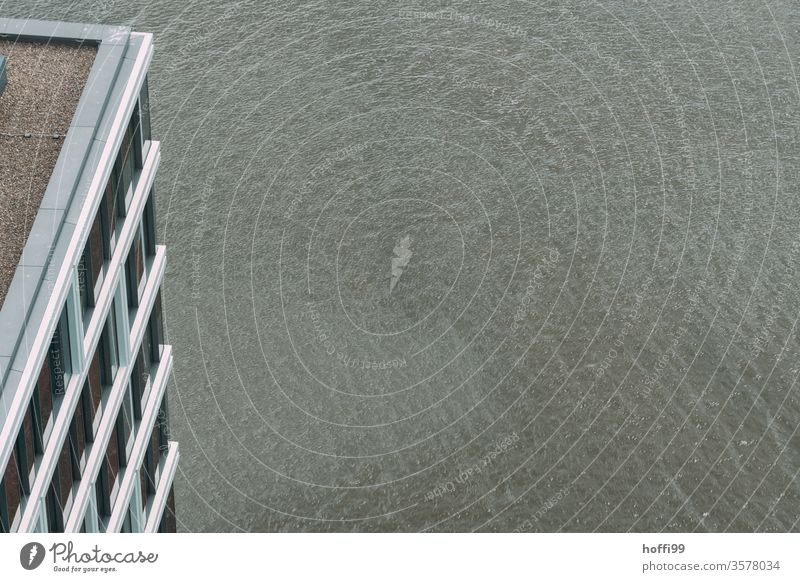 View from above on the water of the Weser with corner of the facade at the edge Minimalistic Facade view from above grey in grey dreariness Gray Gloomy