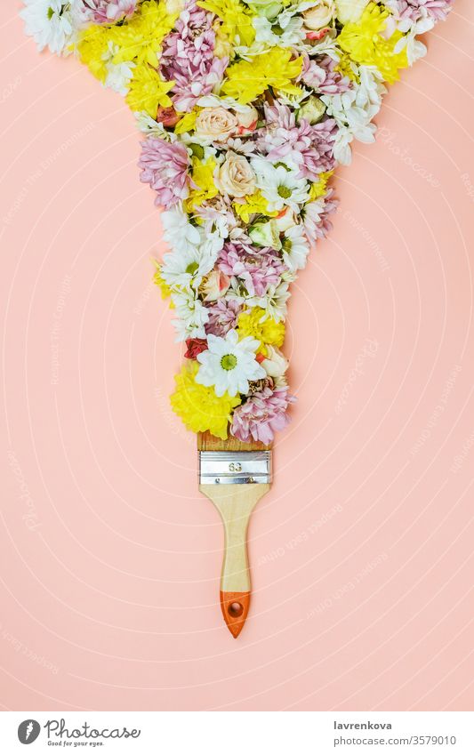 Bristle paint brush with various flowers on pink chrysanthemum colorful plant floral daisy rose petals bouquet creativity bristle lay flat decoration