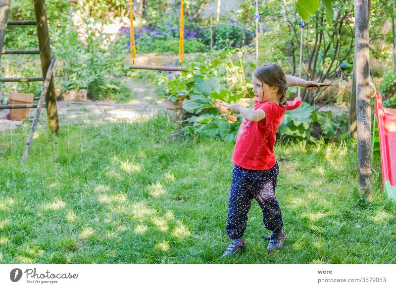 little girl concentrates and throws throwing knives Martial arts competition weapons throwing bullets strong girls defensive Toddler schoolchild