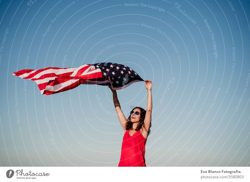 young woman holding United States flag outdoors at sunset. Independence day in America, 4th July concept united states independence day july america freedom
