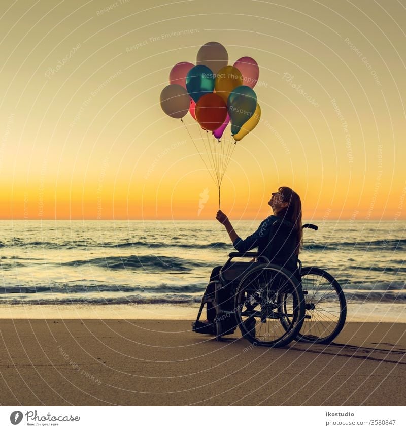 Anything is possible woman wheelchair happy beach balloons sunset handicapped healthcare joy leisure success motivation activity disability relaxing sand sea