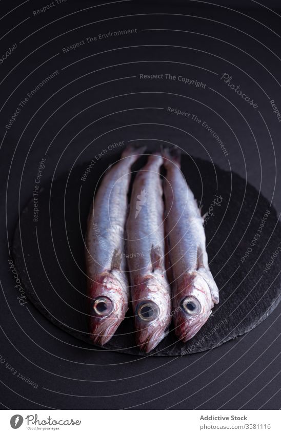 Fresh smelt fish on slate board table kitchen fresh ingredient seafood raw gourmet uncooked culinary product organic tradition healthy cuisine nutrition