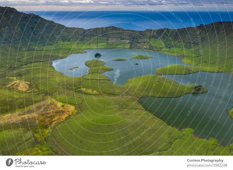 Aerial view of volcanic crater (Caldeirao) with a beautiful lake on the top of Corvo island. Azores islands, Portugal. corvo azores landscape nature portugal
