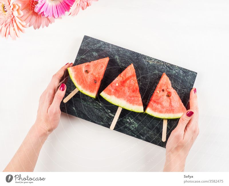 Watermelon slice popsicles on marble tray watermelon summer slices hand pink female woman white wooden table fresh snack berries flowers delicious beautiful