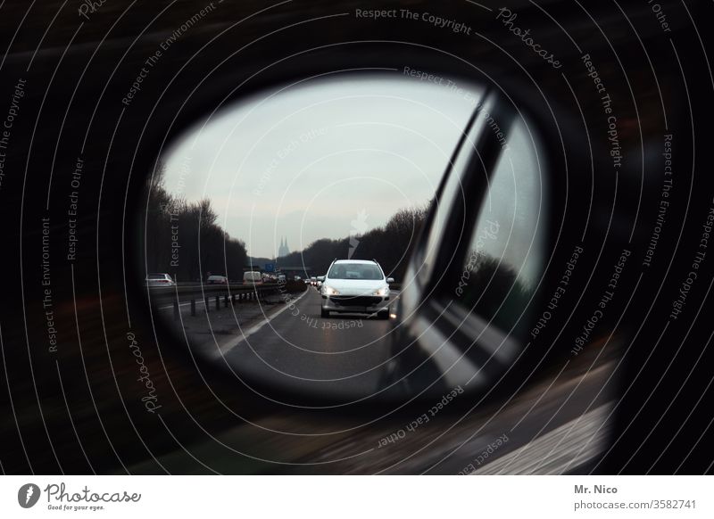 Car in the exterior mirror Rear view mirror Motoring Highway Chase Transport Street Traffic infrastructure Driving Road traffic Speed Vehicle Vacation & Travel
