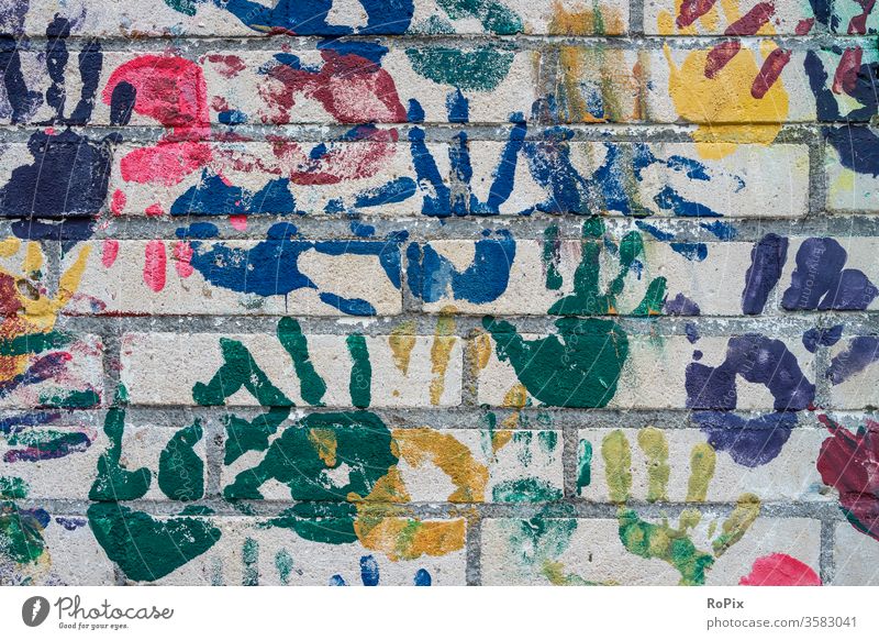 Colorful handprints on the wall of a kindergarten. Wall (building) rampart by hand Fingers brick Brick Architecture House (Residential Structure) house wall