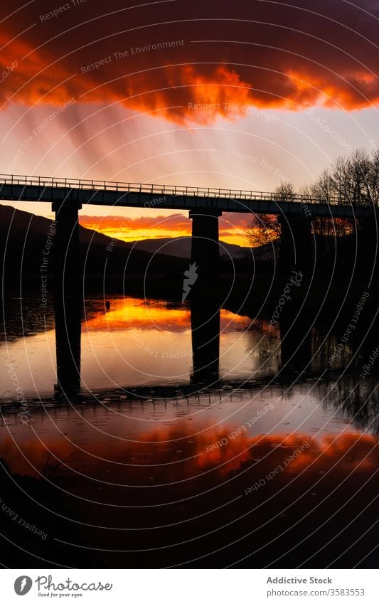Bridge and Lake during sunset in Scotland bridge river lightning sky cloudy evening shore water travel landscape scenic construction architecture energy power