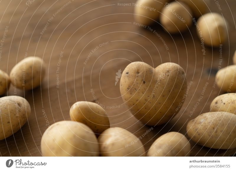 Fresh heart-shaped potatoes on a brown wooden table Nutrition Eating enjoyment Food food Dish organic Harvest Vegetable salubriously Healthy background