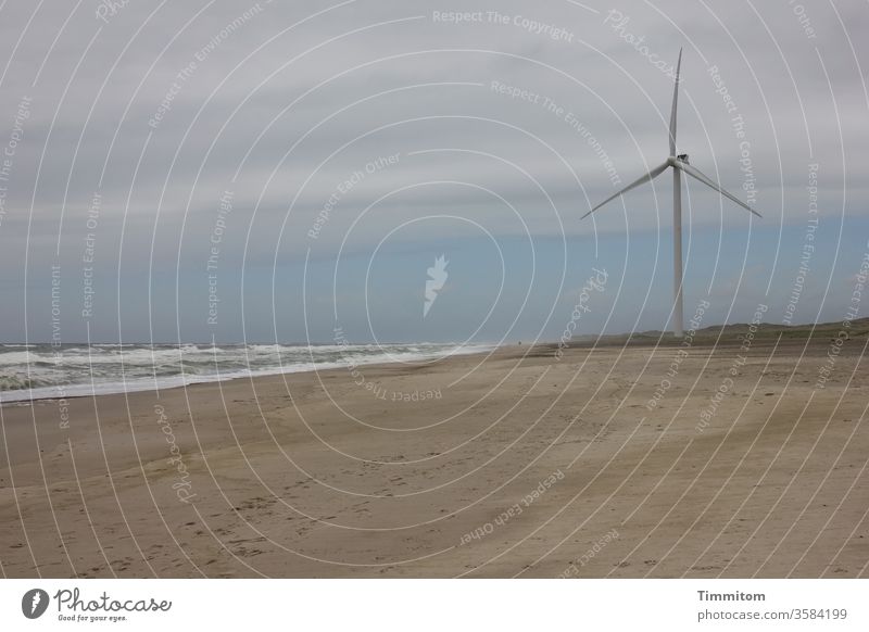 Wind turbine on the Danish North Sea coast Pinwheel Ocean Water Waves Beach Sand Sky Clouds Horizon Denmark Deserted Colour photo White crest traces in the sand