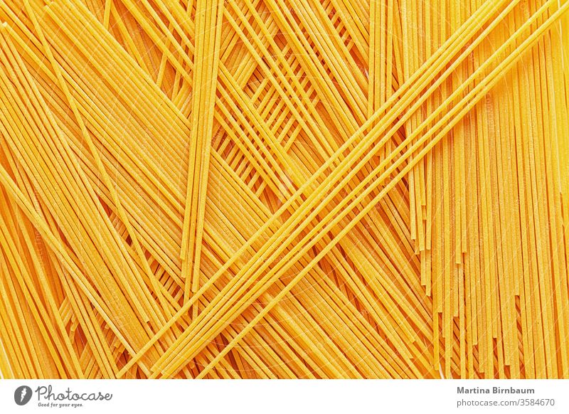Uncooked spaghetti noodles, flat lay dinner cuisine italian food pasta full frame delicious raw yellow no people grain wheat dried food studio shot strand