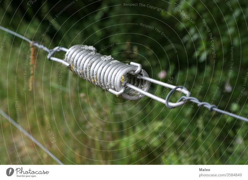 close up of a electrical wire fence around a pasture agriculture animal battery border cattle closeup cow danger disconnect electro energy farm farmer farming