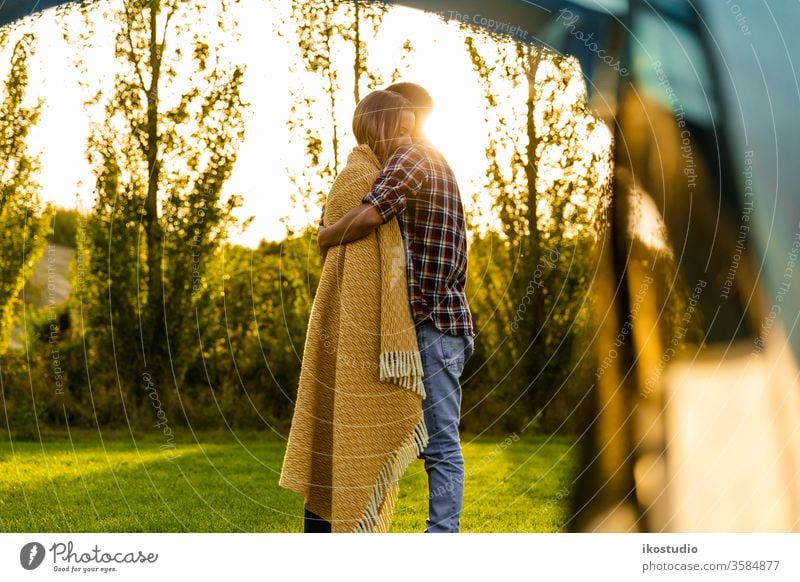 Waking up on a special place couple love hug cuddle relax sunset nature camping tent warm blanket cozy adventure travel friends holidays field boyfriends