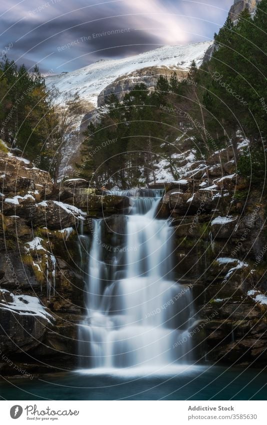 Mountain stream flowing through mountainside landscape waterfall snow cold ice view amazing forest rock incredible winter stone star picturesque dark majestic