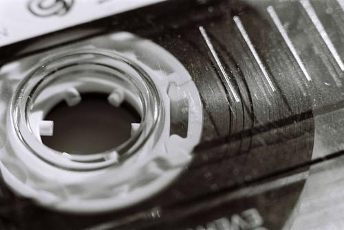Macro close up of an old plastic cassette tape in Black & White music reel b&w black & white black and white old-fashioned outdated oldschool 80s abstract