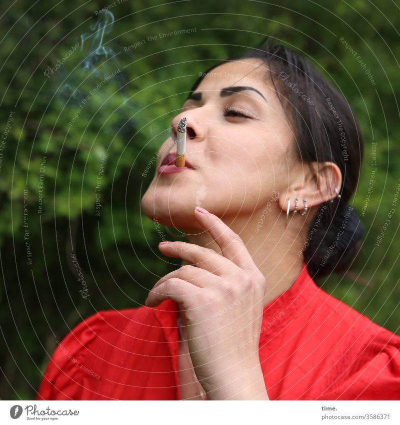Estila Woman feminine Red Smoking Self-confident Nature Jewellery out Dark-haired Long-haired braid To enjoy enjoyment Cigarette by hand Closed eyes Smoke