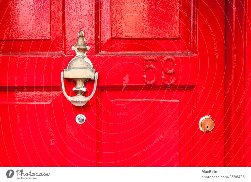 Red front door with brass fittings Entrance Knocker Knock at the door Door lock Brass plaque nobody Copy Space