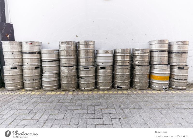 Storage of beer barrels Beer keg beer kegs stacked about each other side by side in a row Backyard empty aluminium barrel aluminium drums nobody Copy Space