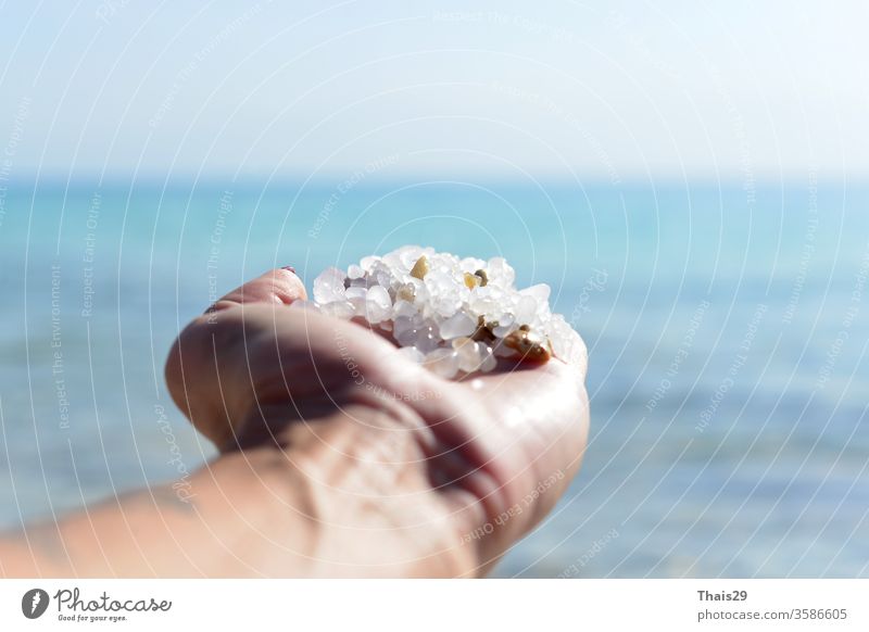 Dead Sea salt natural mineral formation at the Dead Sea in woman hand care health spa female beauty treatment healthy background white view salon bokek travel