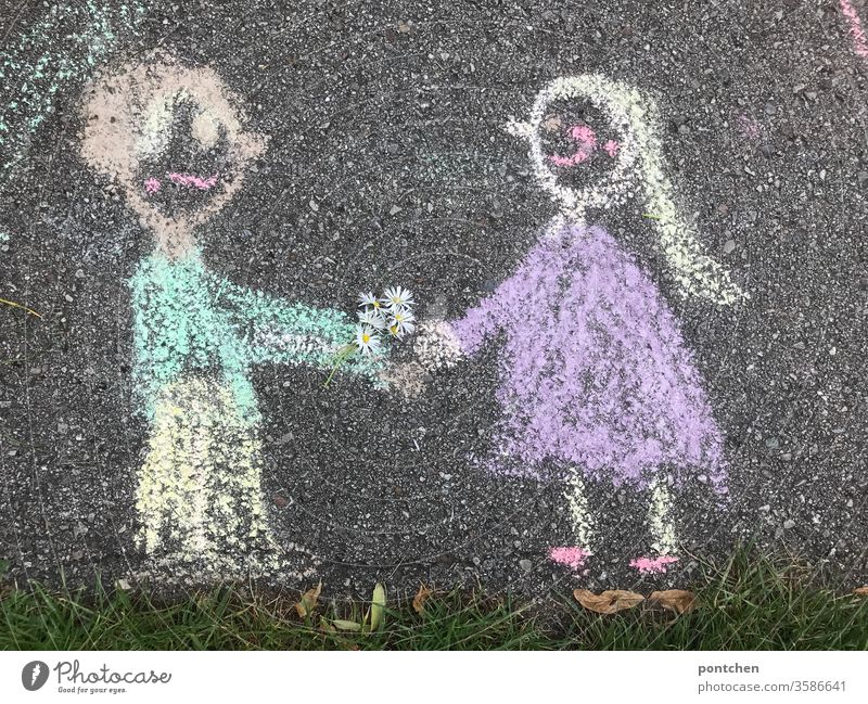 Man presents woman with a self-made bouquet of daisies. Drawing in street chalk. Creativity, child's play. Valentine's Day. Stereotype Bouquet Couple Love hand