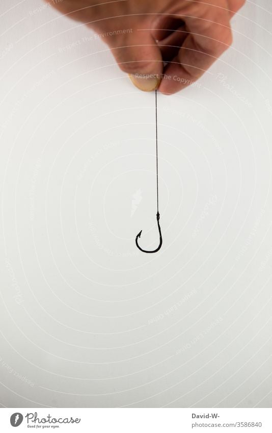 hand holding empty hook on a string Fishing hooks stop Empty Catch Lure To hold on Trap by hand Risk