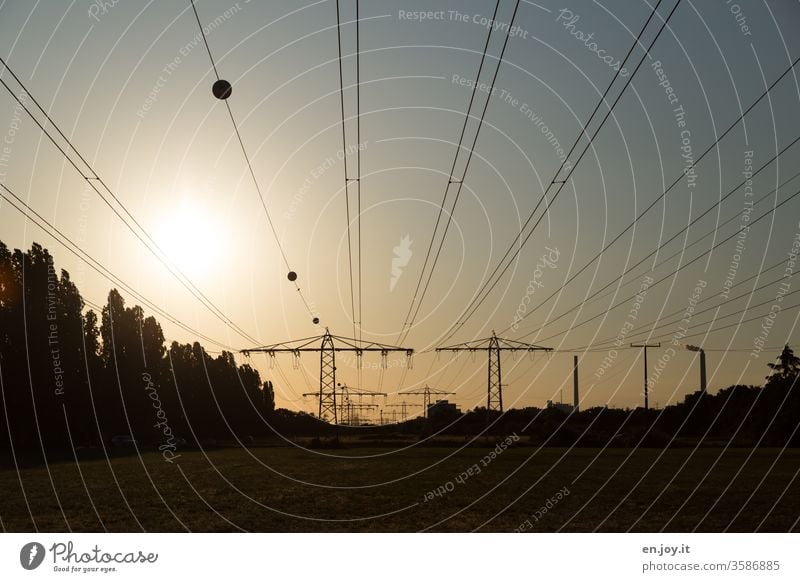 Power lines at sunset stream High voltage power line Electricity pylon Energy Energy industry energy consumption Climate Climate change eco-power okö Sunset