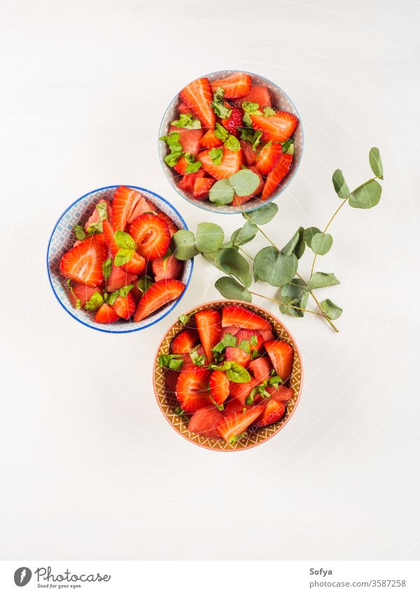 Fruit salad with strawberry, watermelon, basil leaves fruit salad strawberries summer healthy snack bowl ceramic pink white wooden table fresh flowers delicious