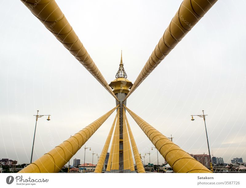Beautifully decorated structure at the top of the bridge tower river architecture pillar gold view building thailand suspension design modern sky landscape