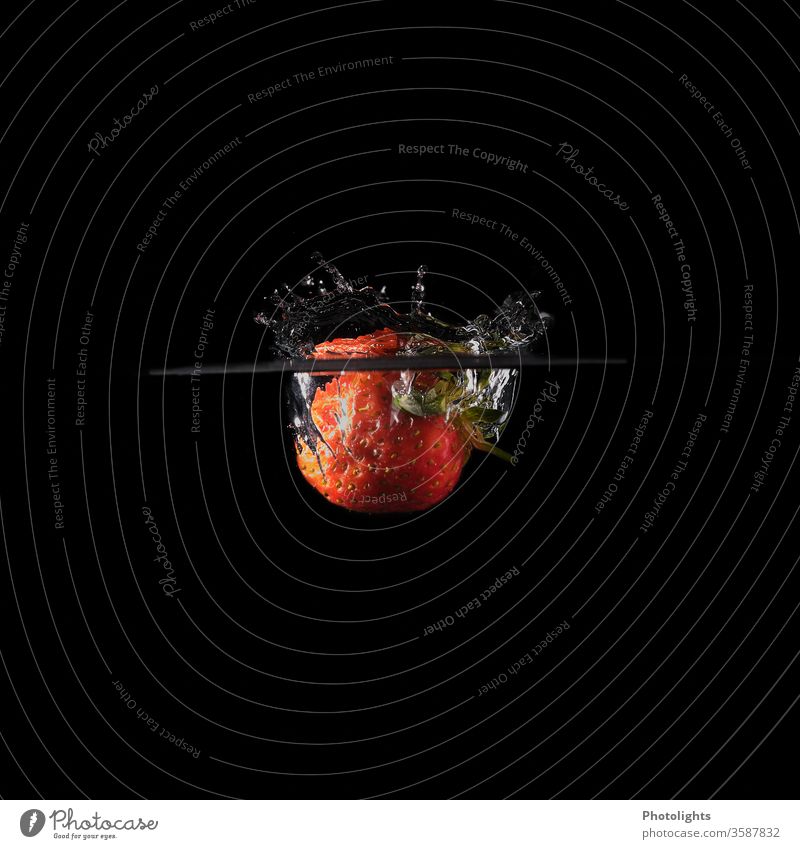 Strawberry falls into water - picture with black background fruit Red Nutrition Food Delicious Colour photo Fresh Healthy Vegetarian diet Organic produce