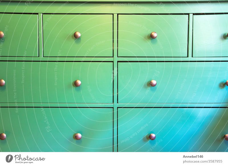 Green cabinet with various drawers, colorful wooden closet close-up retro design background texture flower medical woman business fashion grunge abstract food