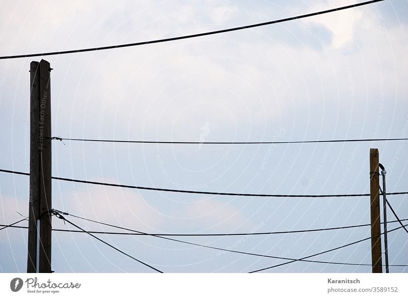 Many power lines draw a pattern in the sky. Sky Blue Clouds cloudy Cable Cables Power lines Tense mast Power poles fixed Hang stream Energy Deliver