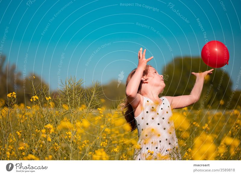 Child in a rape field girl Playing balloon Grasp Catch Field way blossom Blossoming bloom flowers floral Nature Feminine kelid Blonde curly-headed hands