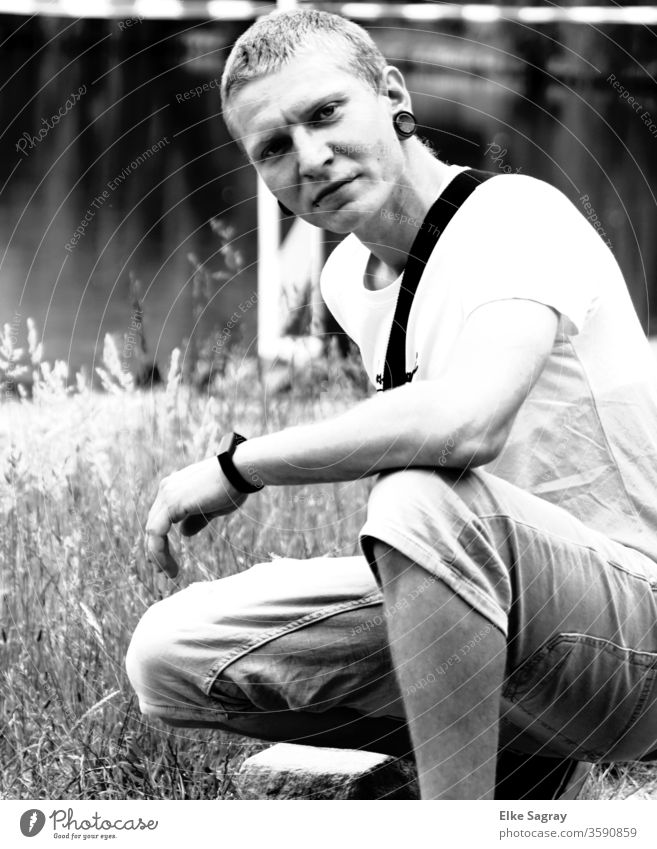 Young man in the grass Youth (Young adults) 18 - 30 years Masculine Black & white photo Exterior shot portrait