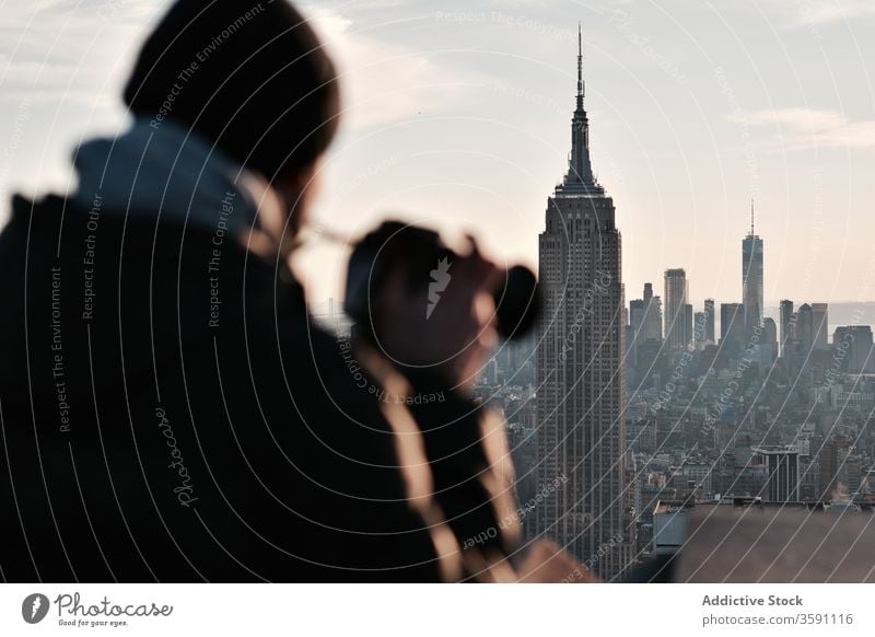 Male photographer admiring cityscape with skyscrapers traveler man admire photo camera sunset moment male megapolis tall manhattan new york usa america
