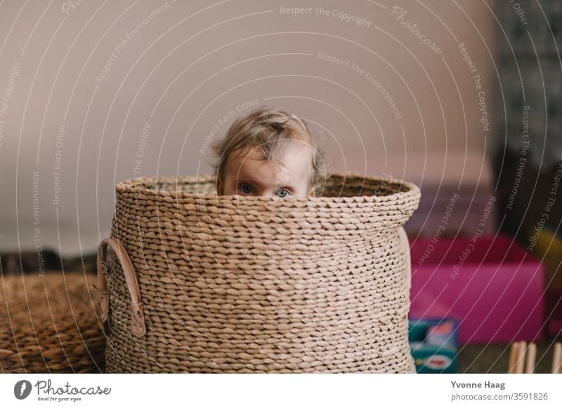 Baby eyes looking out of a basket laughing child Laughter little child little boy little girl Brilliant hiding Hide Relaxation Parenting Childhood memory
