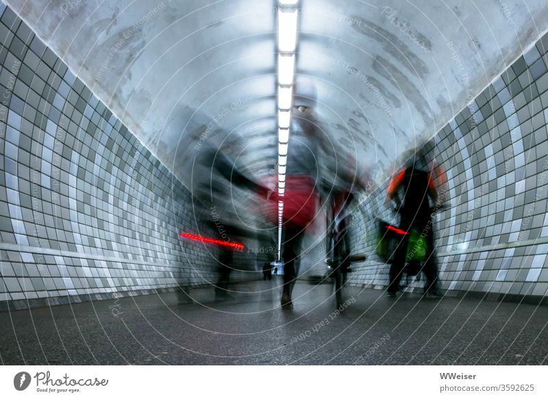 long time exposure, cyclist in pedestrian tunnel cyclists Tunnel reeds descend Push Rear light Long exposure Lighting tiles Transport Movement Hazy Blur Bicycle