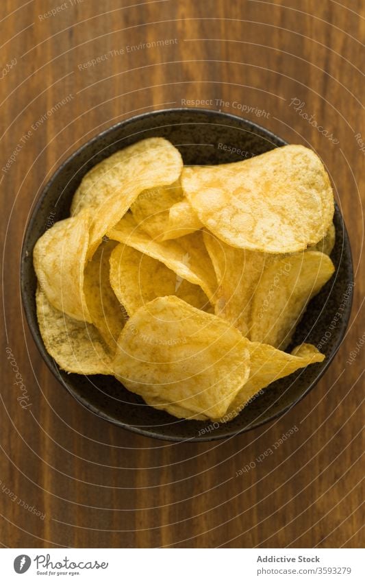 Bowl with potato chips on table crispy pile bowl snack fast food tasty junk food delicious appetizer meal appetizing gastronomy culinary salty dry yummy gourmet