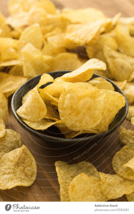 Bowl with potato chips on table crispy pile bowl snack fast food tasty junk food delicious appetizer meal appetizing gastronomy culinary salty dry yummy gourmet