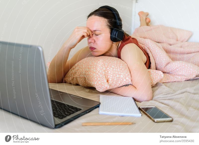 Woman working from home in her bed. Tired and stress woman computer laptop female learning tired bedroom business businesswoman person indoors professional