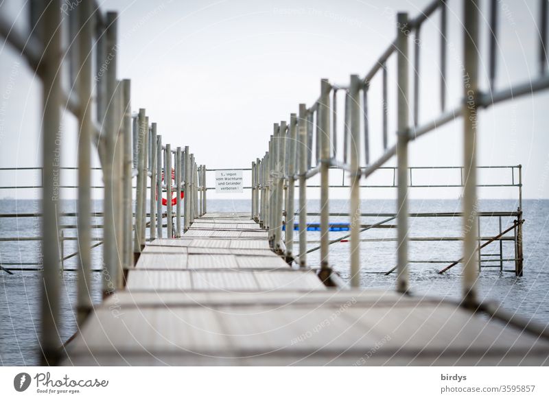 A deserted bathing area at the Baltic Sea Ocean Footbridge Bathing facilities Deserted corona off Horizon free time Vacation & Travel Coast Signage parapet
