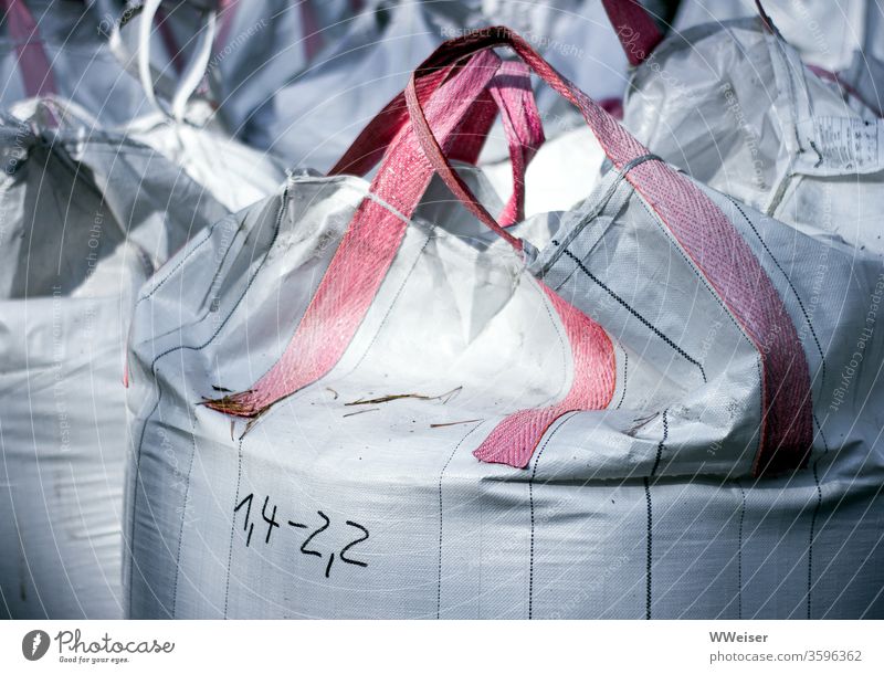 White bags on a construction site Construction site Sack Sandbag Full Carrying bag Carrying handles Heavy figures Specification Weight Build building material