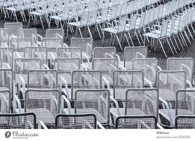 Empty rows of chairs of an open air stage outdoor Chair rows White Diagonal Steel seats Twilight open-air stage empty seats no spectators Deserted Seating