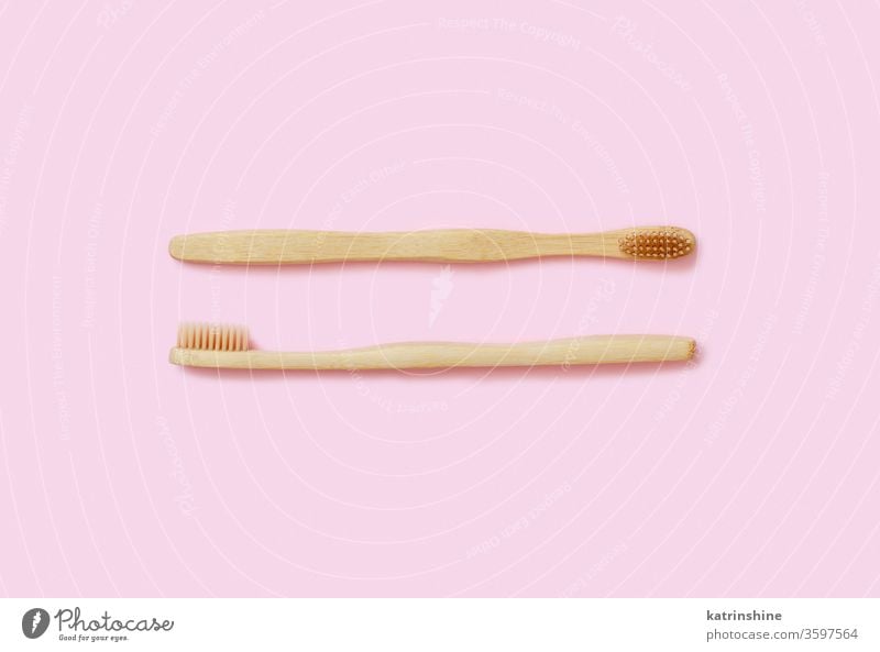 Eco friendly bamboo toothbrushes on pink background waste concept light pink top view zero waste tooth brushes health alternative cleaning above dental