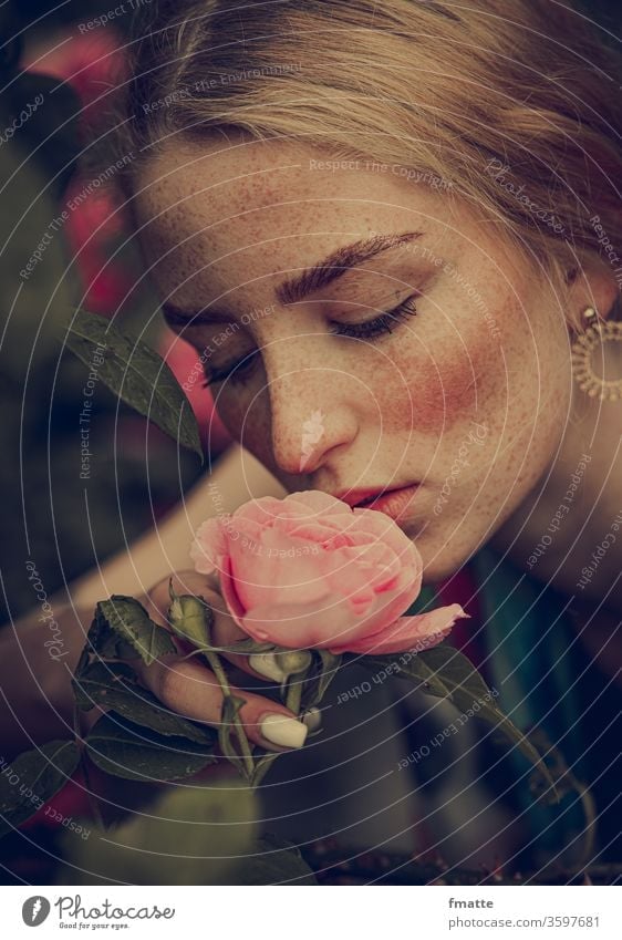 Young woman smells a rose Woman flowers Summer bleed Joy Fragrance Beauty & Beauty Beauty in nature Freckles Plant already natural Blossom leave Floral Pink