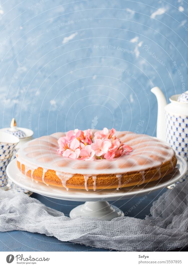 Bundt cake with frosting. Festive treat spring flowers bake easter pastel color pink blue delicious romantic elegant textile selective focus soft bundt