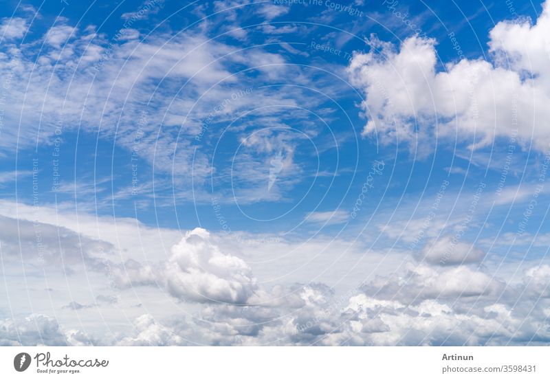 White fluffy clouds on blue sky. Soft touch feeling like cotton. White puffy clouds cape with space for text. Beauty in nature. Close-up white cumulus clouds texture background. Sky on sunny day.