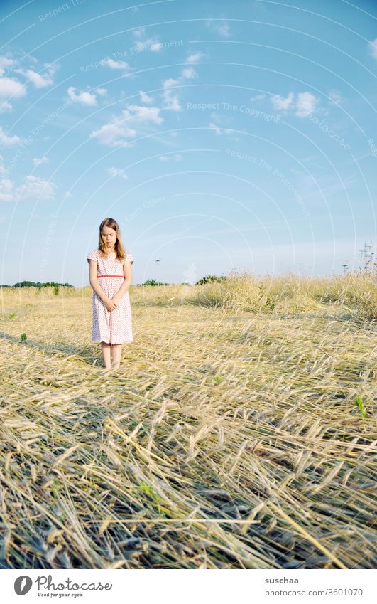 child on a summery straw chopper, looking down rather sceptically Child girl Summer Dress straw field Grain field well-behaved Skeptical Looking Posture steiff