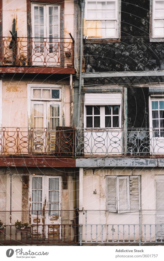 Shabby facade of residential building in city exterior aged house weathered shabby architecture background texture porto portugal construction old metal grunge