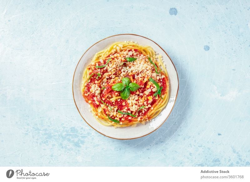 Italian pasta. Spaghetti with tomato sauce, cheese and basil, overhead shot with a place for text italian plate spaghetti red parmesan leaves food eating dish